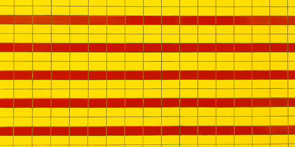 Red and yellow line wall tile texture in vintage background retro