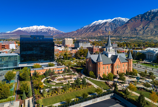 Downtown Provo, Utah aerial, with the Provo City Center Temple on the right (also the former Provo Tabernacle) and One Nu Skin Plaza on the left, with the snow capped Wasatch Mountain Range in the background.