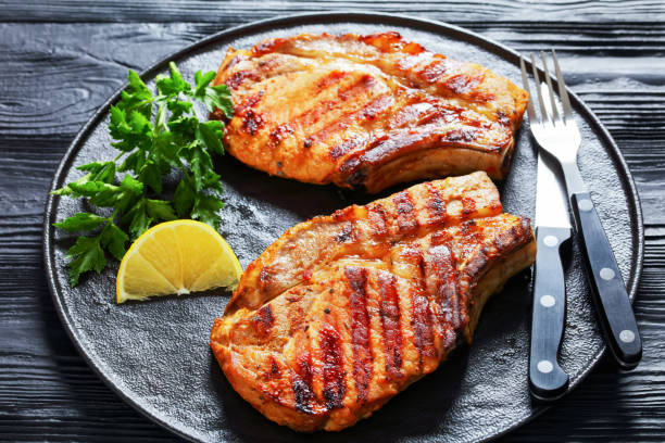 istock grilled bone-in pork chops on a black plate 1368537779