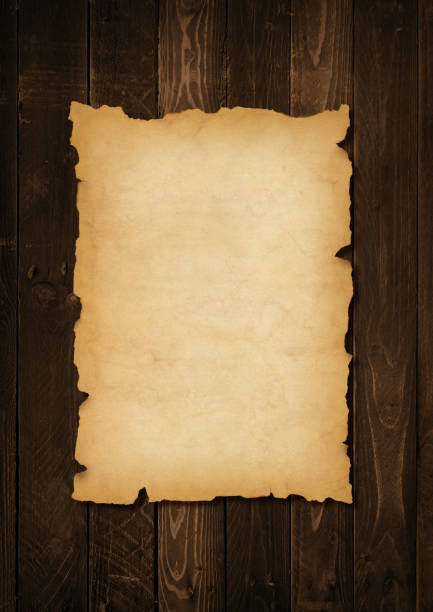 istock Old mediaeval paper sheet. Parchment scroll on a wood board 1368537824