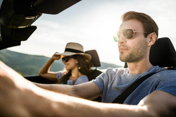 istock Couple going on a road trip by convertible car. 1368538162