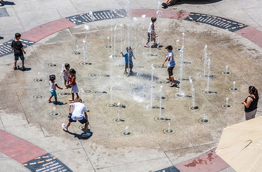 Los Angeles, USA - July 5 , 2008:  children play at fountain for actors at The Hollywood and Highland Center and entertainment complex at Hollywood Boulevard in Los Angeles, USA.
