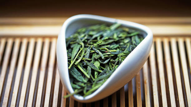 Chinese green tea Dragon Well in Tea presentation vessel, macro