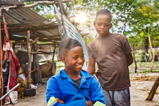 two happy African children in the yard of an African village