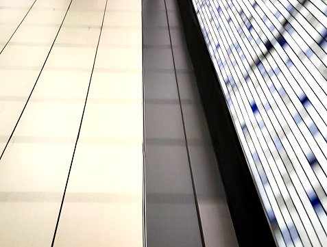 In camera movement of a tiled floor with illuminated wall in London Underground.