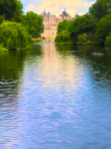 The lake in St James's Park in London with Buckingham Palace in the background. London, England, UK.  Post processed to give a painterly glow.