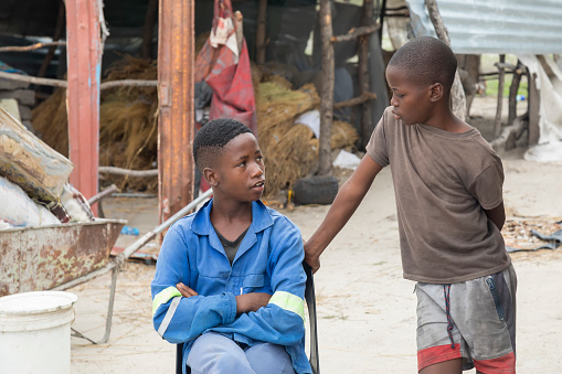 African kids talking in the yard of their house in a village in Botswana,