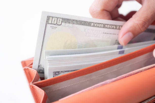 istock Finger holding bank note dollar for take from pocket wallet close up on white background. 1368545853