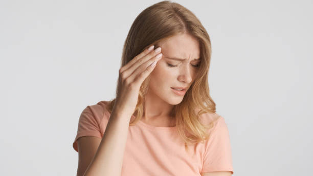 istock Young upset woman keep hand on temple feeling headache isolated 1368546034