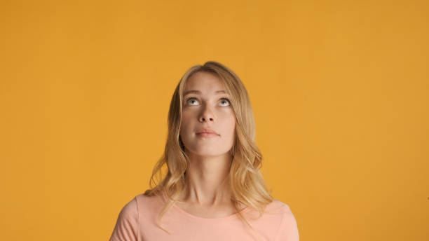 istock Beautiful girl intently looking up on copy space for text or adv 1368546052