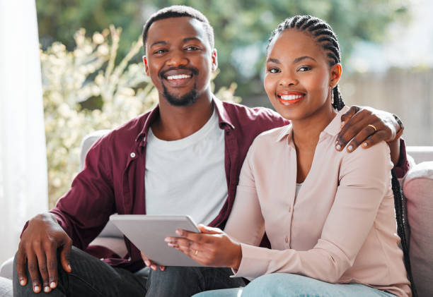 istock Shot of a young couple relaxing at home using a digital tablet 1368546115