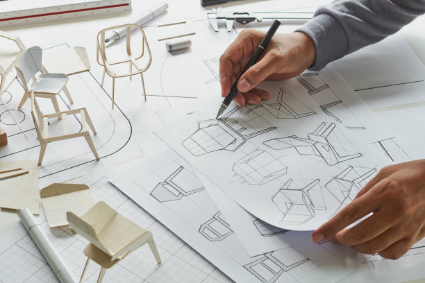 istock Designer sketching drawing design development product plan draft chair armchair Wingback Interior furniture prototype manufacturing production. designer studio concept . 1368546204