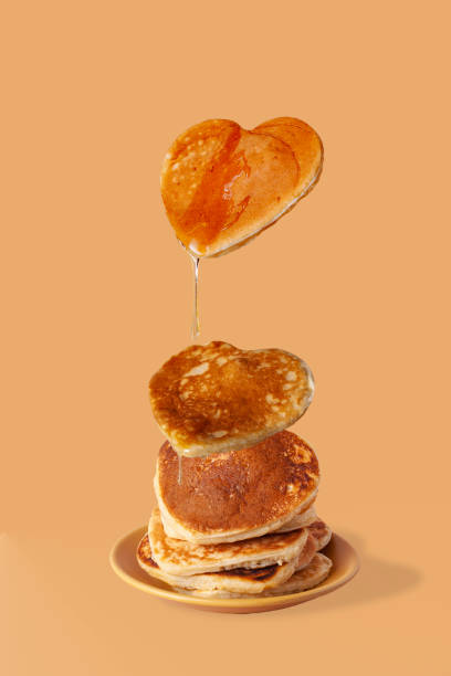 istock heart shaped pancakes with honey drops on beige background 1368547594