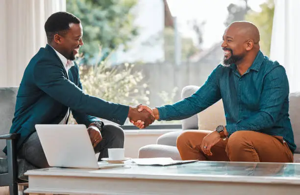 Photo of Shot of two businessmen shaking hands in agreement