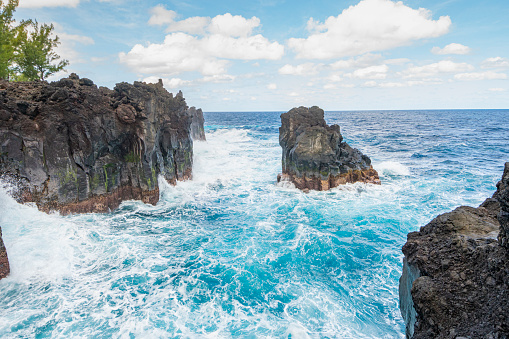 Lava rocks natural volcanic pools in Porto Moniz, Madeira island, Portugal. Dramatic seascape. Beauty of nature concept background. Panoramic view.