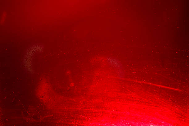 istock Glass with water drops on red background. 1368549926