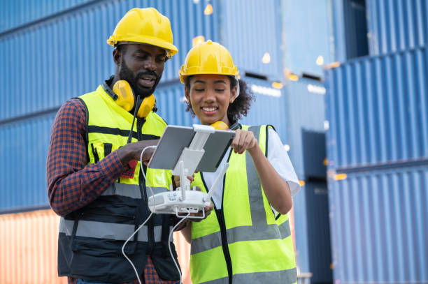 istock Engineering, foreman play drone of remote control with blue containers background 1368550163
