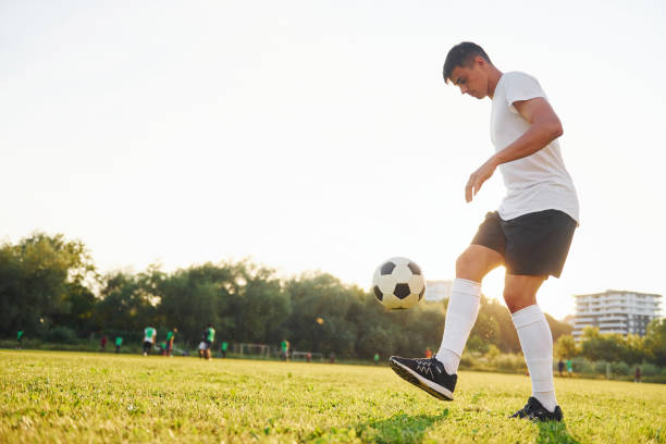 istock Doing different tricks. Young soccer player have training on the sportive field 1368550981