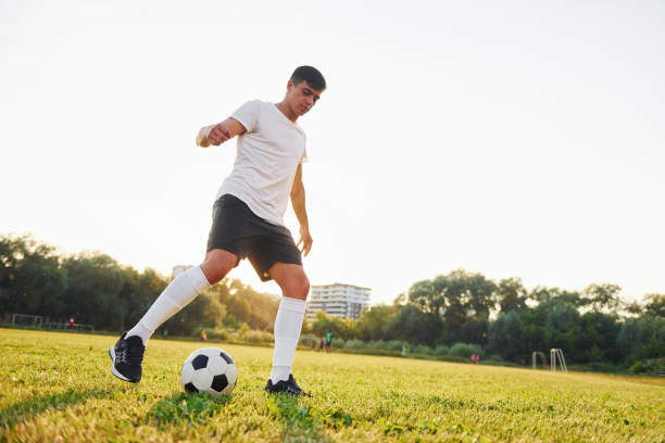 istock Forest on background. Young soccer player have training on the sportive field 1368551013