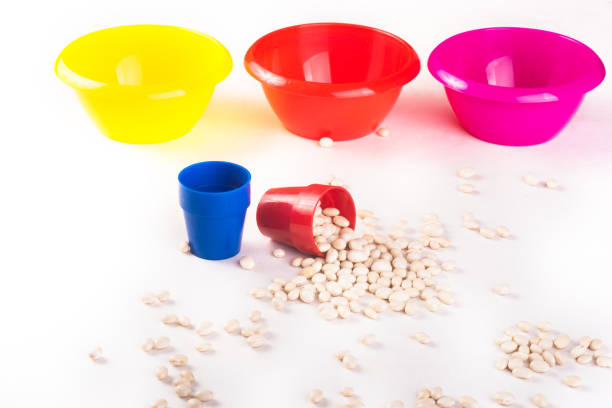 Developing lessons for young children. The development of fine motor skills. Haricot, beans and colored plastic bowl. Natural toys. Kindergarten. sorting game