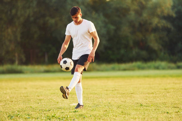 istock Professional practice. Young soccer player have training on the sportive field 1368551563