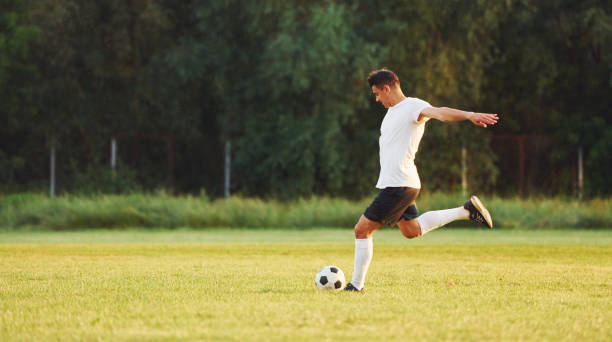 istock Professional practice. Young soccer player have training on the sportive field 1368551575