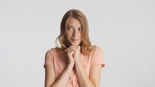 istock Pretty girl keep hands under chin dreamily looking away over whi 1368552636