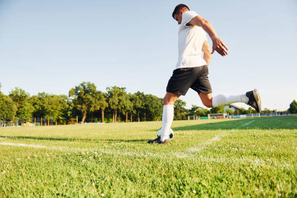 istock Sunny daytime. Young soccer player have training on the sportive field 1368552836