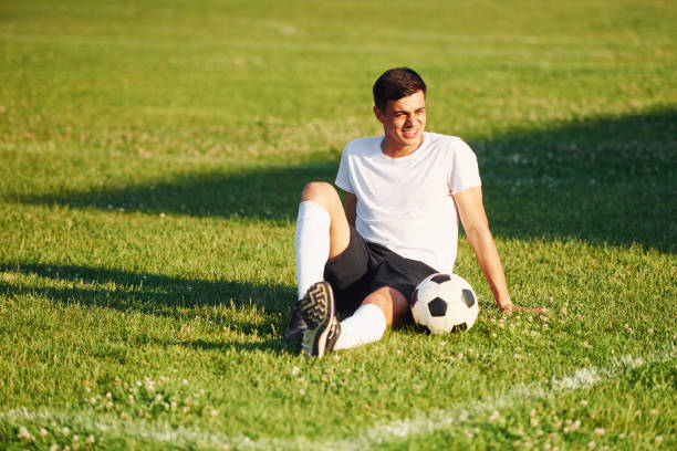 istock Takes a break. Young soccer player have training on the sportive field 1368552893