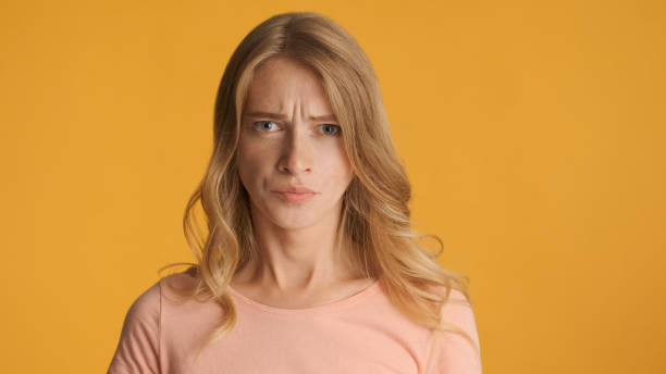 istock Offended girl angrily looking in camera over colorful background 1368552999