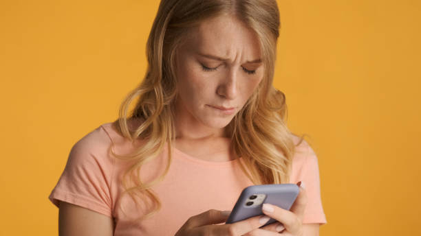 istock Unhappy girl holding smartphone feeling sad because didn't get m 1368553109
