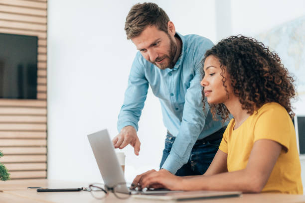 istock Two business persons talking in the office 1368554420