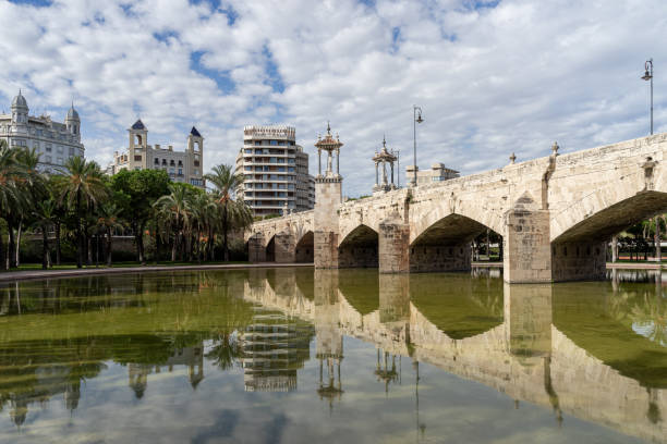 istock Ancient stone bridge across old river bed. Puente del Mar, Turia river, Valencia, Spain 1368554535
