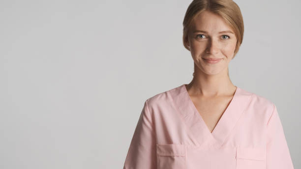 istock Attractive doctor happily looking in camera with copy space near 1368554708