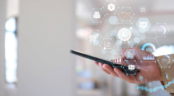 istock Businessman uses his smartphone to analyze sales data and an economic graph chart in order to resurrect his company's growth. 1368555082