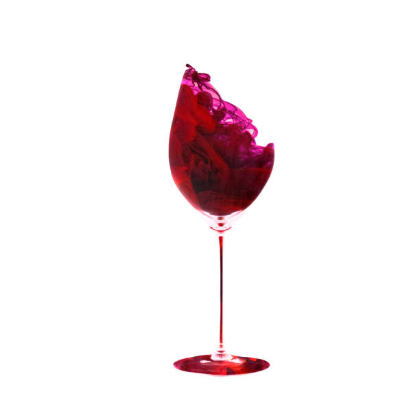 istock Creative artwork. Red wine texture made of red dye, liquid with drops and splashes. One wine glass isolated on white background. Concept of drinks, taste, holidays, festivals 1368555632