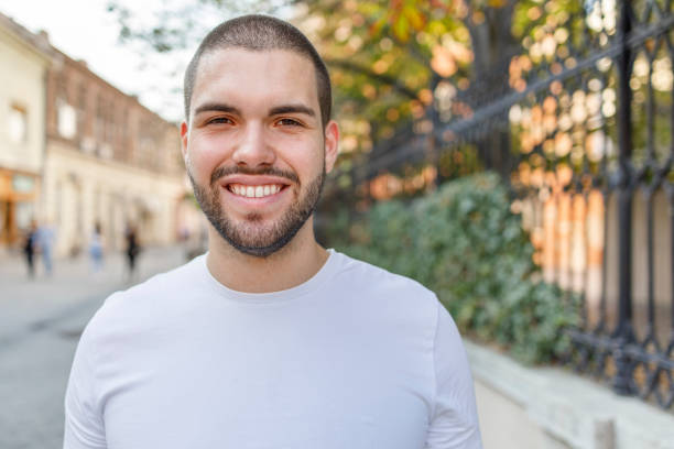istock Portrait of a young man smiling 1368556190