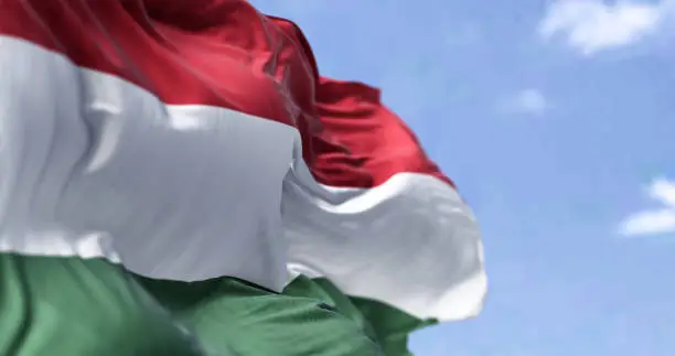 Photo of Detail of the national flag of Hungary waving in the wind on a clear day