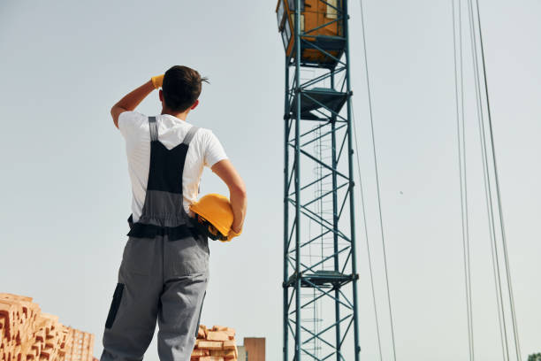 istock Taking a break. Young construction worker in uniform is busy at the unfinished building 1368559298