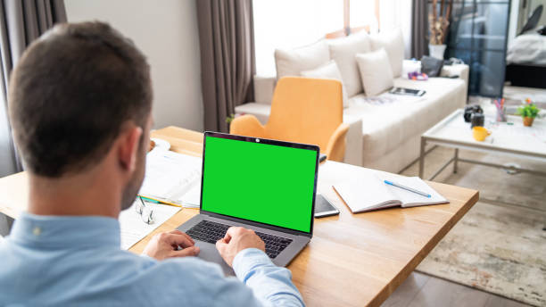 istock Young father working on a laptop at home during covid lockdown, while kids stuff are scattered around 1368559363