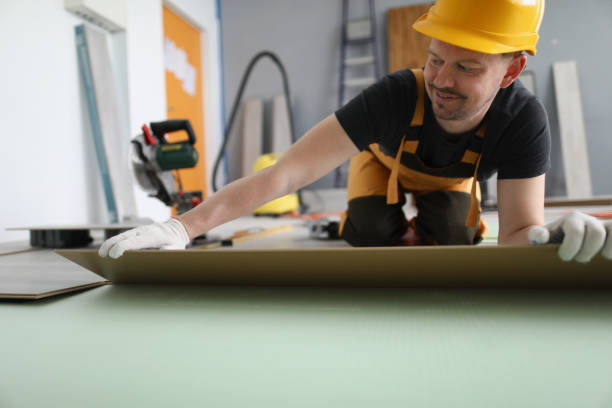 istock Handyman set wooden panel of laminate floor, installing floor in flat 1368560688