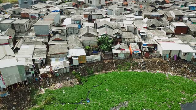 View of slum lakeside with slum houses