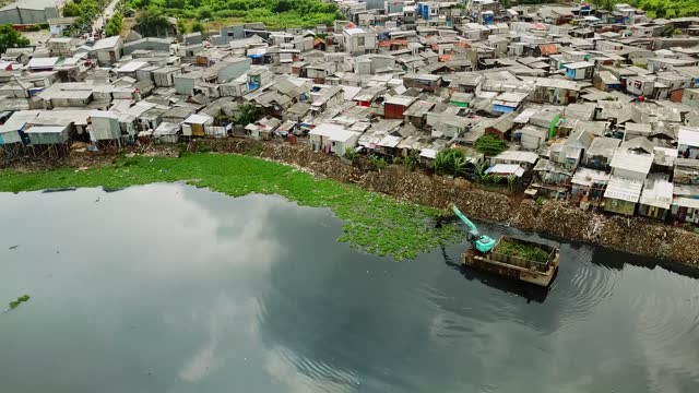 Landscape of slum houses and huts on lakeside