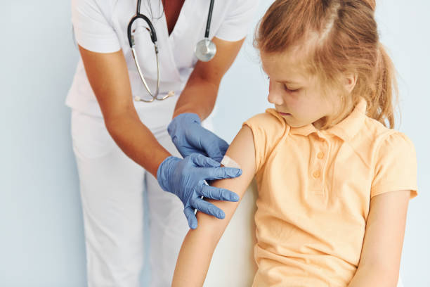 istock Professional occupation. Doctor in uniform making vaccination to the patient 1368561445