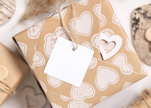 istock Valentines present with blank gift tag and hearts close up, Rustic label Mockup 1368563706