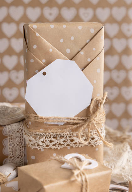 istock Valentines present with blank gift tag and hearts close up, Rustic label Mockup 1368563719