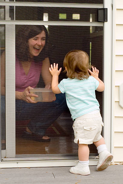 Toddler at the Screen Door stock photo