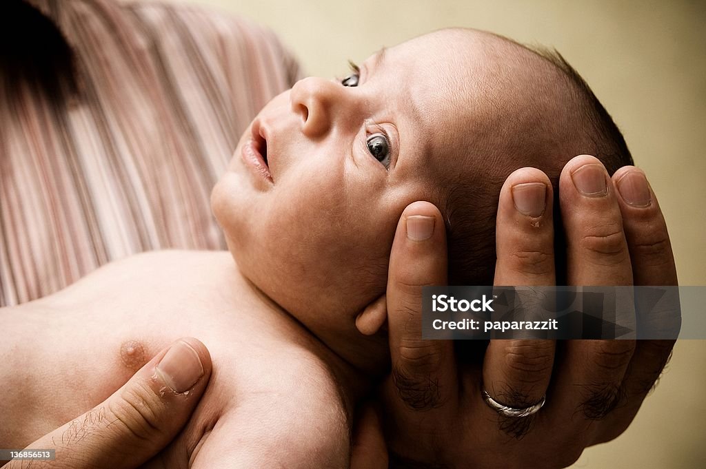 bably look small baby in her father's hand Animal Body Part Stock Photo