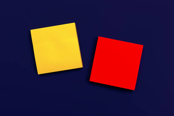 istock blank yellow square sticky note and red square sticky note on dark blue background, top view. Blank space for future important events announcements 1368565219
