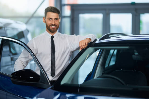 istock Businessman visiting auto salon for choosing new vehicle 1368565337